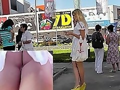 Sexy blonde in white dress lures up skirt camera